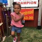 Happy girl posing by trophies display